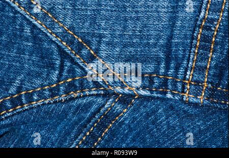 A close up section of a blue denim jacket, showing seams, creases and textures. Stock Photo