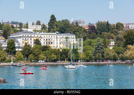 Waterfront view of posh Beau-Rivage Palace hotel in Ouchy area, Lausanne city, Switzerland on Lake Leman (Geneva Lake) on hot sunny summer day Stock Photo