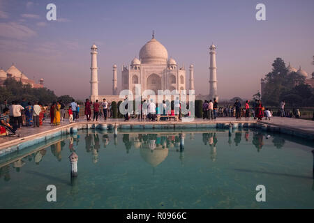 Tajmahal,morning ,Sun,reflection,in green water pool with tourists,foreign,and Indian,two mosque,in,East, West,under blue sky,patchy,white clouds,Agra Stock Photo