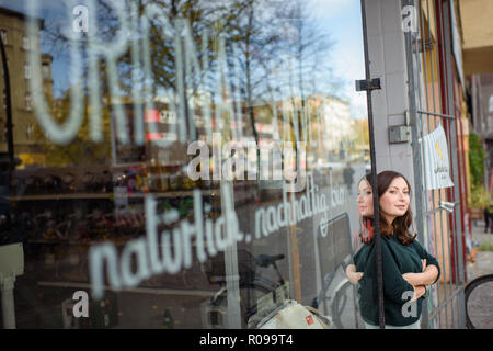 Berlin, Germany. 02nd Nov, 2018. Milena Glimbovski, founder and managing director of the store 'Original Unverpackt', is standing next to the entrance door shortly after opening the store. For her commitment to the environment, she was named Berlin entrepreneur of the year. Their store, opened four years ago, sells food without repackaging for a more sustainable shopping experience. Credit: Gregor Fischer/dpa/Alamy Live News Stock Photo