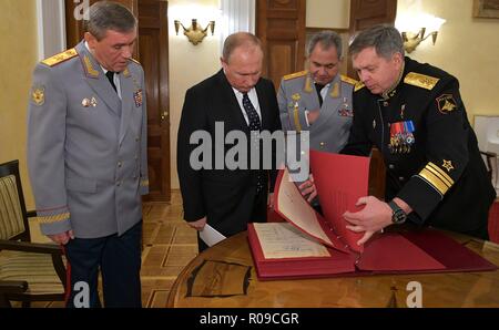 Moscow, Russia. 2 November 2018. Russian President Vladimir Putin, center, views historic papers from the GRU before a gala event to mark the centenary of the Main Directorate of the General Staff of the Armed Forces of Russia at the Russian Army Theatre Standing with the president from left to right are: Chief of the General Staff of the Armed Forces of Russia Valery Gerasimov, President Vladimir Putin, Defence Minister Sergei Shoigu, and First Deputy Chief of the Main Directorate of the General Staff of the Armed Forces of Russia, Vice Admiral Igor Kostyuk Credit: Planetpix/Alamy Live News Stock Photo