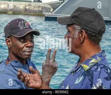 Nassau, New Providence, Bahamas. 16th Jan, 2009. Two Bahamian fishermen have a discussion on the docks of Nassau, capital of the Bahamas, and a popular cruise-ship destination. Credit: Arnold Drapkin/ZUMA Wire/Alamy Live News Stock Photo