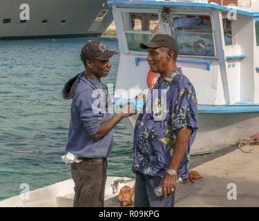 Nassau, New Providence, Bahamas. 16th Jan, 2009. Two Bahamian fishermen have a discussion on the docks of Nassau, capital of the Bahamas, and a popular cruise-ship destination. Credit: Arnold Drapkin/ZUMA Wire/Alamy Live News Stock Photo