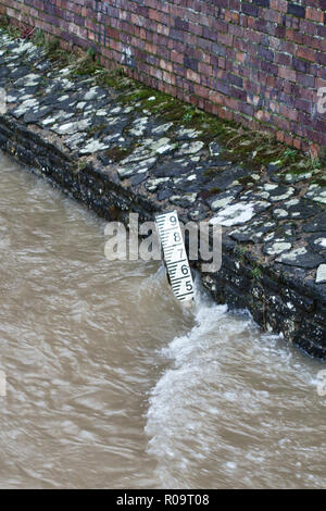 Presteigne, Powys, mid Wales, UK. The River Lugg in winter, at high flood level beneath the town's old 17c stone bridge Stock Photo
