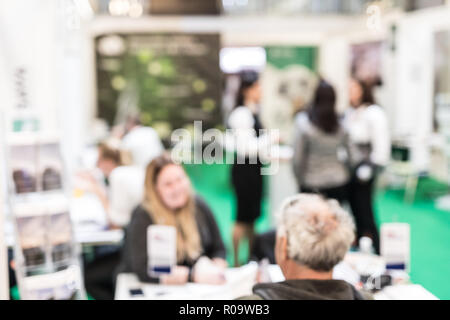 Anonymous blurred people discussing business at a trade fair. Stock Photo