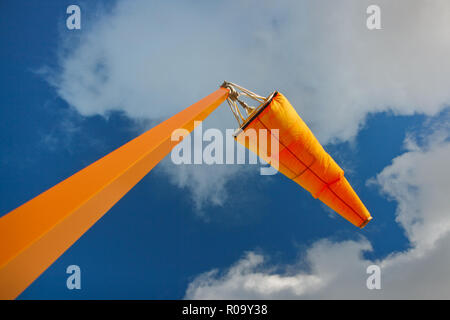 Orange airport windsock and sky. Stock Photo