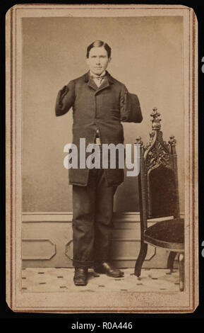 Richard D. Dunphy, former U.S. Navy Sailor with Amputated Arms, was Coal Heaver aboard USS Hartford during American Civil War and was Wounded during Battle of Mobile Bay, Awarded Congressional Medal of Honor, Full-length Standing Portrait, 1864 Stock Photo