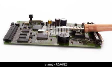 computer micro circuit board with iron soldering and tin wire in electronic laboratory Stock Photo