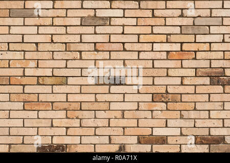 Faded brick wall background. Colored bricks facade. Stock Photo