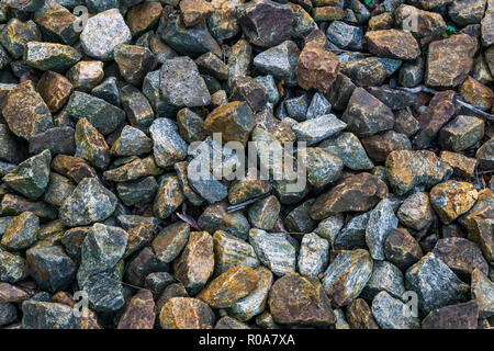 granite pebble stones ground garden decoration in many different colors and shapes macro closeup background Stock Photo