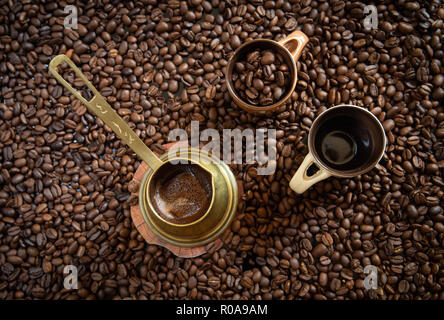 Fresh Cyprus coffee on a cup ready to be served and brown beans ready to make delicious cup of coffees Stock Photo