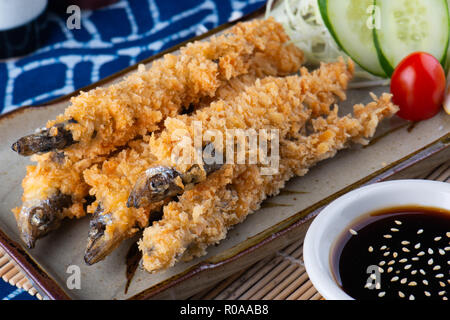 Shishamo fish deep fried serve with Japanese sauce style. Stock Photo