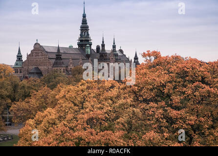 Exterior of Nordic Museum (Nordiska museet) on Djurgarden island, with autumn coloured trees in the foreground, Stockholm, Sweden Stock Photo