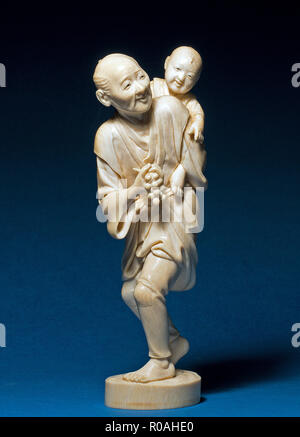 Ivory japanese okimono on dark background Stock Photo