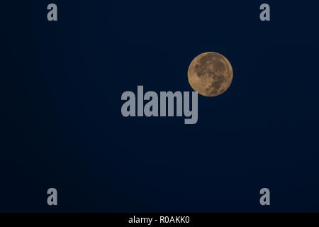 Orange full moon against dark sky, background Stock Photo