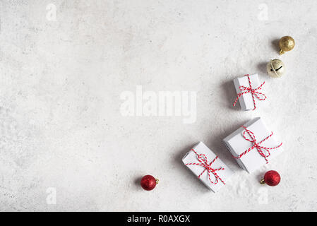 Christmas Gift Boxes on white background, copy space. White Christmas Gifts and golden balls, winter festive composition, mockup, concept. Stock Photo