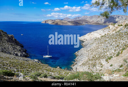 Yacht anchored in Dolphin Bay, on the holiday destination, Kalymnos, Dodecanese, Greece, Greek, Island, Greek Islands Stock Photo