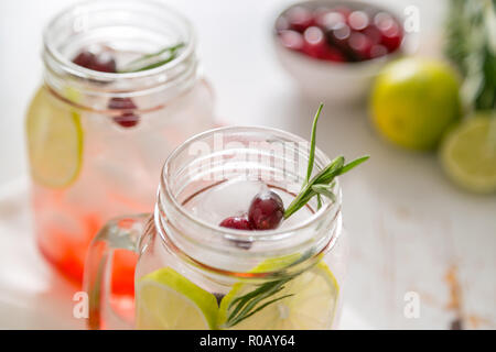 Cranberry lemonade in glass jar, garden backgro