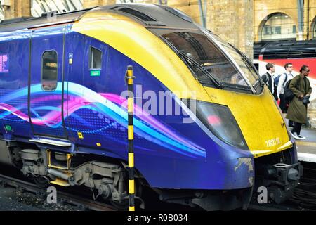 London, England, United Kingdom. A locomotive that lead a recent arrival at  London King's Cross Station idles as exiting passengers walk past. Stock Photo