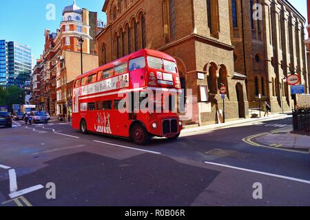 London, England, United Kingdom. Traffic, including a time-honored Routemaster double-decker bus converted to tour bus service.