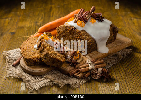 Carrot cake with autumn decorations, rustic wood background Stock Photo