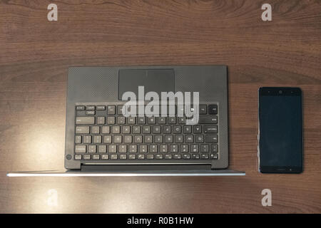 Modern laptop on a table with phone Stock Photo