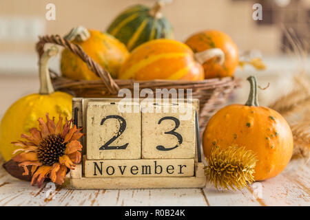 Thanksgiving concept - calendar date with decorations and pumpkins on  kitchen background Stock Photo - Alamy