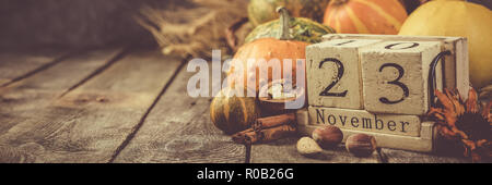 Thanksgiving concept - calendar date with decorations and pumpkins on  kitchen background Stock Photo - Alamy