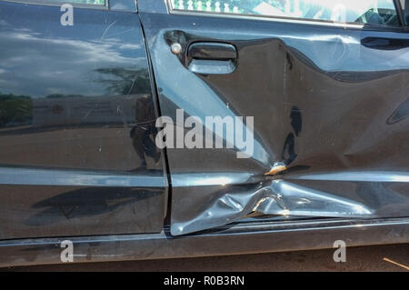 Dented car door after a car accident. Stock Photo