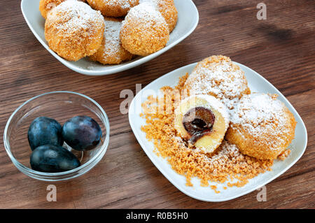 Plum dumplings on wooden table Stock Photo