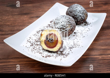 Plum dumplings on wooden table Stock Photo