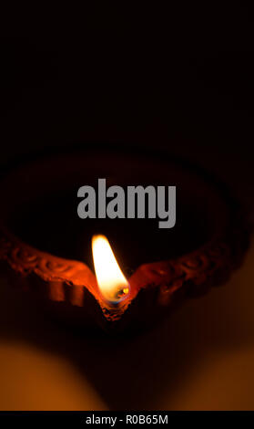 Closeup of Diwali terracotta diyas on dark background which are used  lighting up the house during diwali times Stock Photo - Alamy