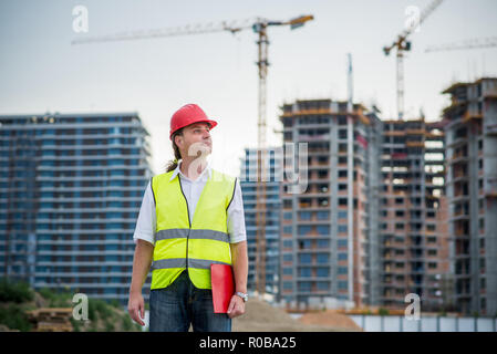Engineer on a construction site working on housing project Stock Photo