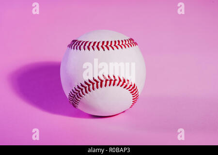 baseball on a Pink color background and red stitching baseball. copy space. Stock Photo
