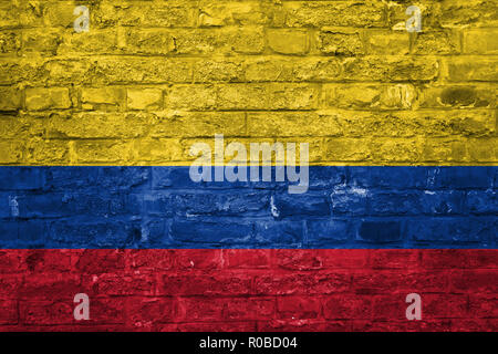 Flag of Colombia over an old brick wall background, surface Stock Photo