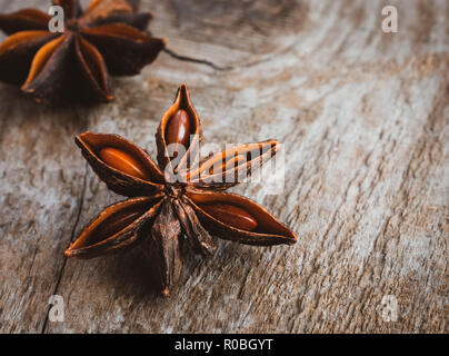 Two star anise on a wooden background close up Stock Photo