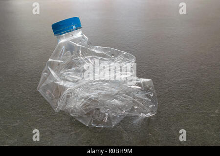 Plastic water bottle crushed and pressed for recycling, recycle concept, less volume Stock Photo