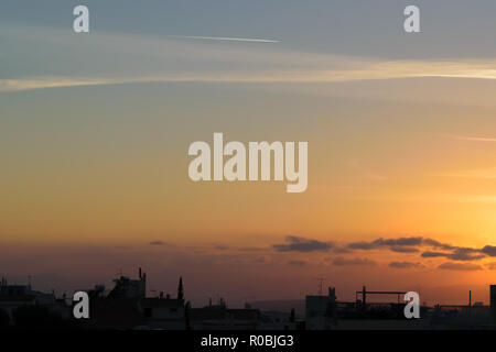 Sunset with cityscape in dark shadow, blue orange soft colors Stock Photo