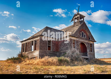 The old schoolhouse in the ghost town of Govan, Washington is rumored to be haunted by past murders. Stock Photo