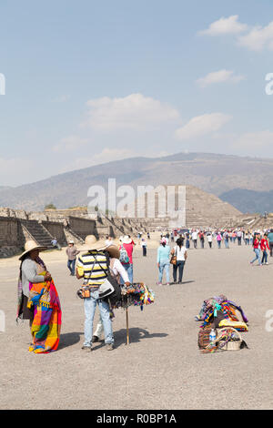 Teotihuacan, Mexico. Tourists walking around the Teotihuacan Archaeological site with the Pyramide of the Moon in the background, Stock Photo