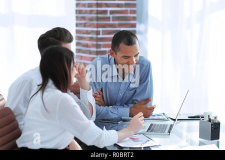 business team discussing new ideas sitting at his Desk Stock Photo