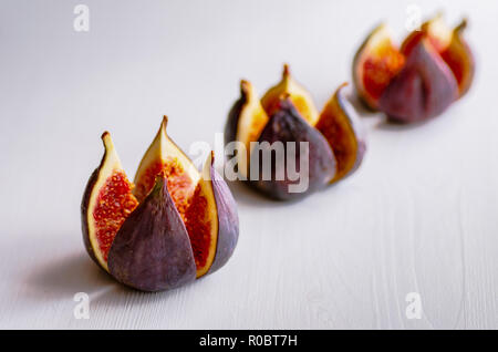 Ripe figs on a white wooden background. Treatment of anemia. Potassium for the heart. Stock Photo