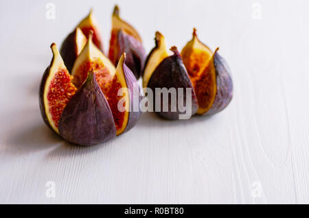 Ripe figs on a white wooden background. Treatment of anemia. Potassium for the heart. Stock Photo