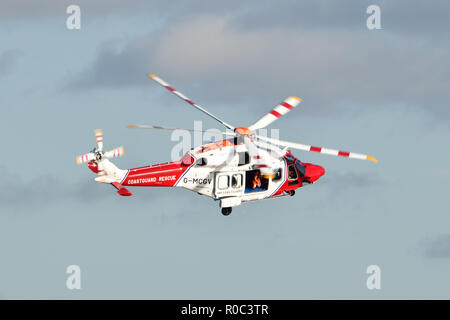 Coastguard rescue helicopter taking part in a search and rescue mission over the river Thames in East London Stock Photo