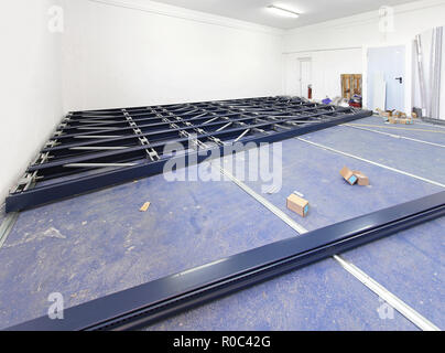 Automated shelving system during construction in empty storage room Stock Photo