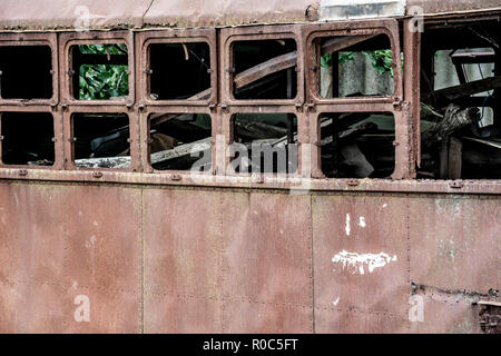 Rusty abandoned and destroyed tram wagon. At the scrap dump. Stock Photo