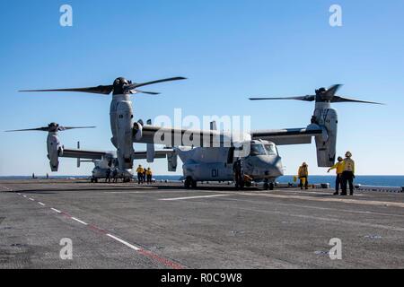 181029-N-KW492-0153 ATLANTIC OCEAN (Oct. 29, 2018) Sailors prepare to launch MV-22 Ospreys on the flight deck of the Wasp-class amphibious assault ship USS Kearsarge (LHD3) during the Carrier Strike Group (CSG) 4 composite training unit exercise (COMPTUEX). COMPTUEX is the final pre-deployment exercise that certifies the combined Kearsarge Amphibious Ready Group's and 22n Marine Expeditionary Unit's abilities to conduct military operations at sea and project power ashore through joint planning and execution of challenging and realistic training scenarios. CSG 4 mentors, trains and assesses Eas Stock Photo