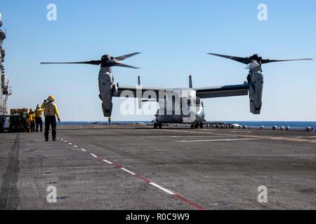 181029-N-KW492-0164 ATLANTIC OCEAN (Oct. 29, 2018) An MV-22 Osprey prepares to take off from the flight deck of the Wasp-class amphibious assault ship USS Kearsarge (LHD3) during the Carrier Strike Group (CSG) 4 composite training unit exercise (COMPTUEX). COMPTUEX is the final pre-deployment exercise that certifies the combined Kearsarge Amphibious Ready Group's and 22nd Marine Expeditionary Unit's abilities to conduct military operations at sea and project power ashore through joint planning and execution of challenging and realistic training scenarios. CSG 4 mentors, trains and assesses Eas Stock Photo