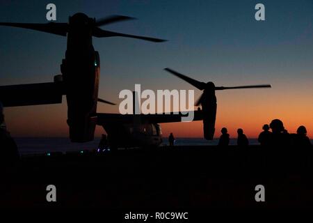 181031-N-WH681-0073 ATLANTIC OCEAN (Oct. 31, 2018) An MV-22 Osprey prepares to take off from the flight deck of the Wasp-class amphibious assault ship USS Kearsarge (LHD 3) as part of an amphibious assault exercise during the Carrier Strike Group (CSG) 4 composite training unit exercise (COMPTUEX). COMPTUEX is the final pre-deployment exercise that certifies the combined Kearsarge Amphibious Ready Group's and 22nd Marine Expeditionary Unit's abilities to conduct military operations at sea and project power ashore through joint planning and execution of challenging and realistic training scenar Stock Photo