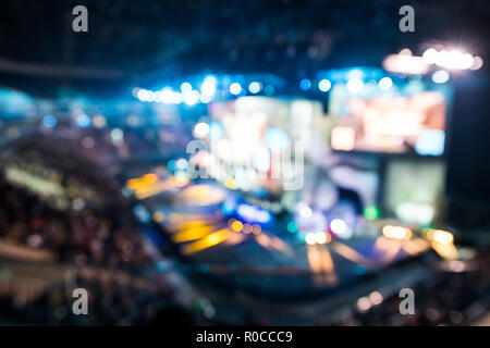 Blurred background of esports event at big arena with a lot of lights and screens Stock Photo